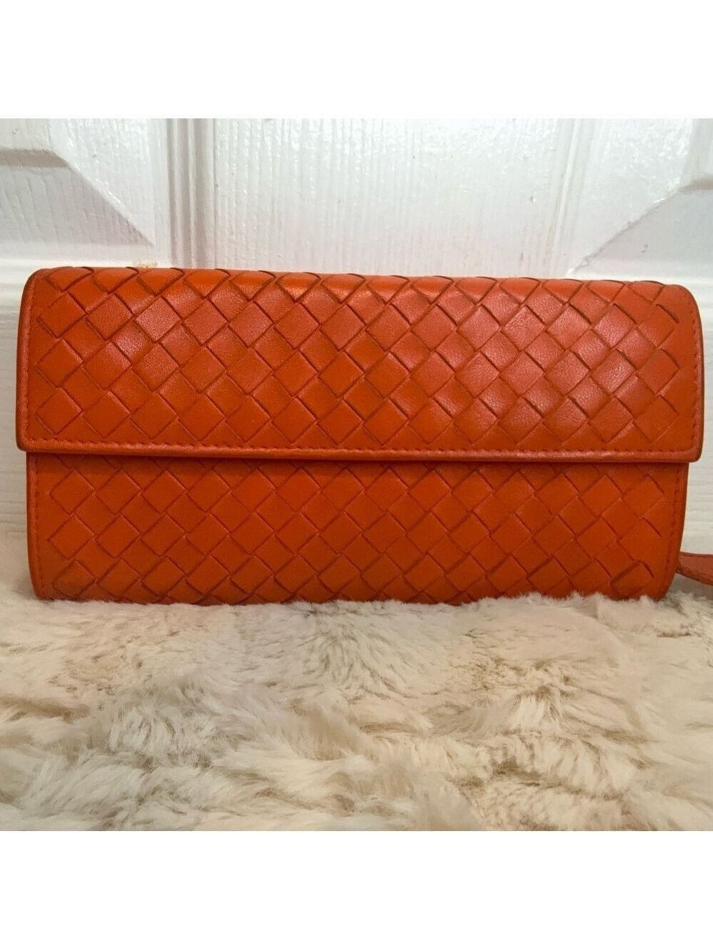 BOTTEGA VENETA INTRECCIATO CONTINENTAL LONG WALLET IN ORANGE